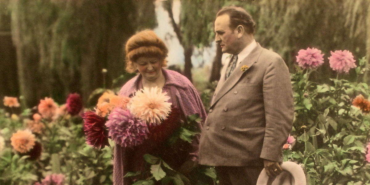 Carrie and Clyde Tingley standing in flower garden