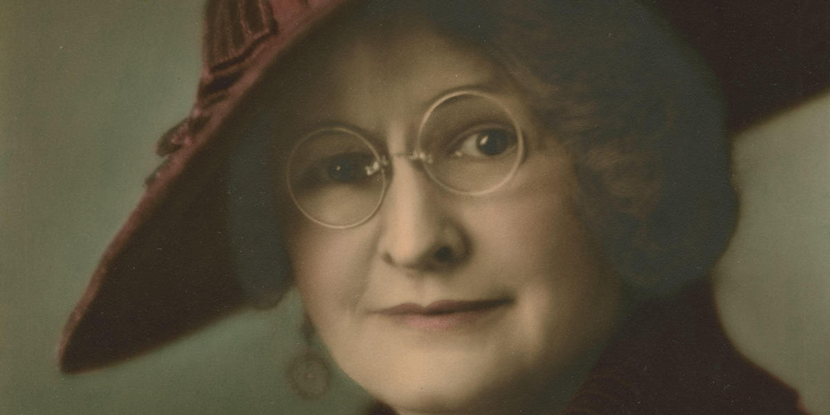 Color portrait of Carrie Tingley wearing glasses and hat