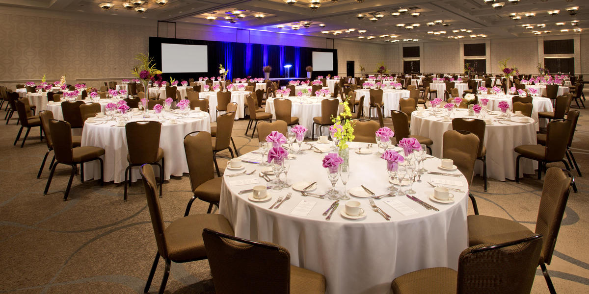 Rounds with place settings in Grand Ballroom